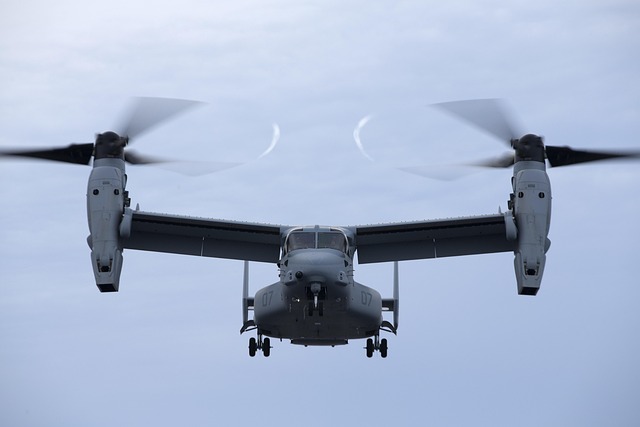 Photo of a compound helicopter or tiltrotor aircraft in flight, such as the V-22 Osprey