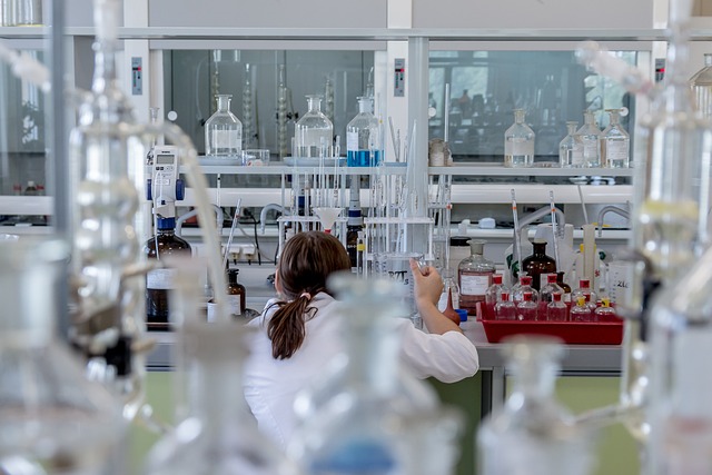 Scientist in lab coat performing an experiment, with a notebook containing 'expt.' shorthand